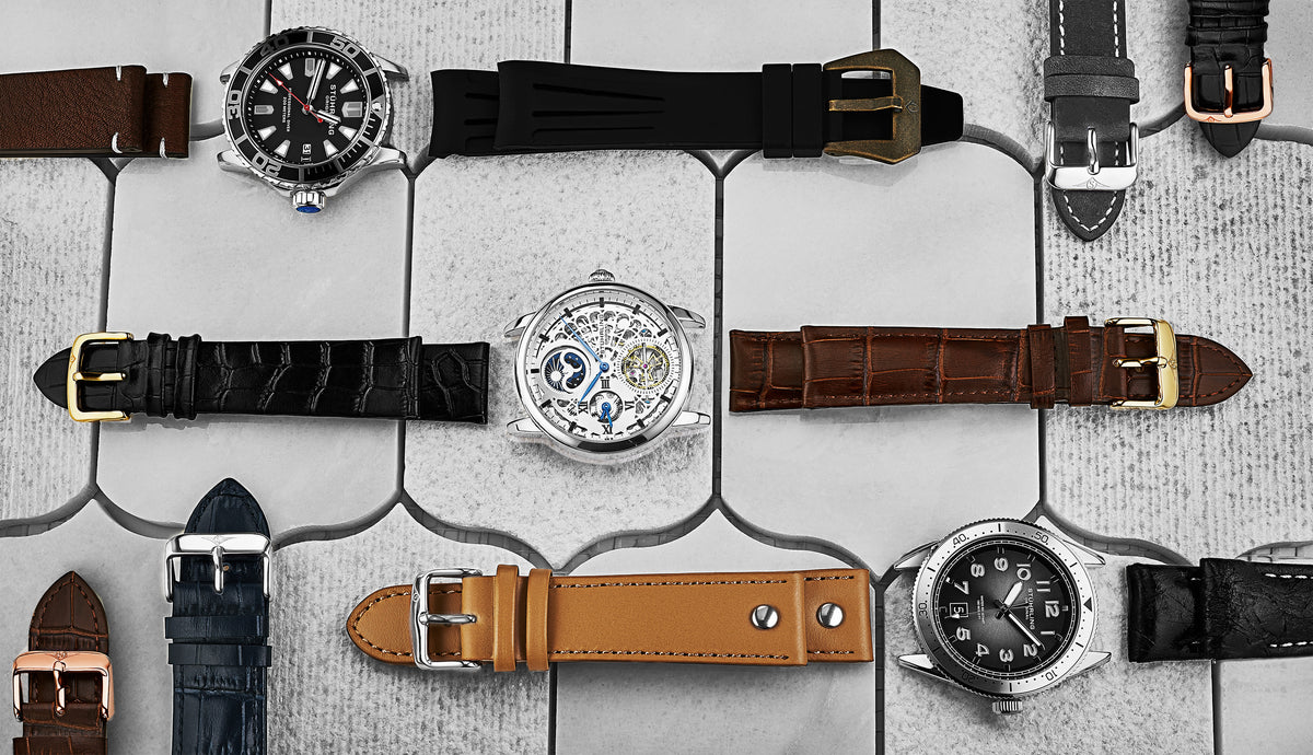 Collection of watches with various straps on a tiled surface