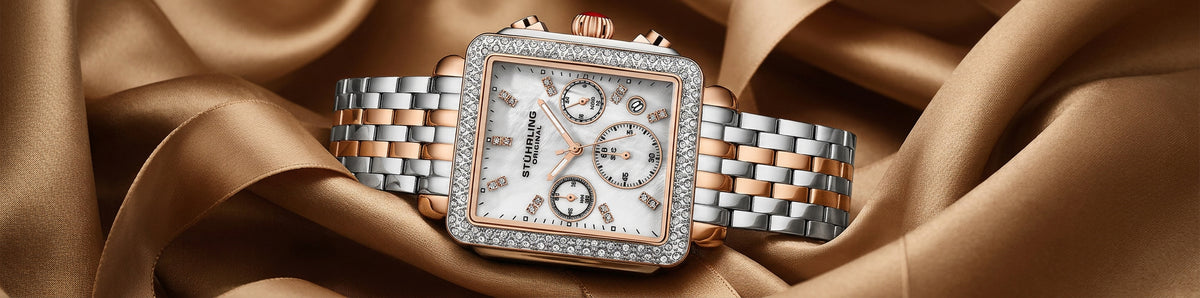 Luxury watch with diamond-studded face on a brown fabric background